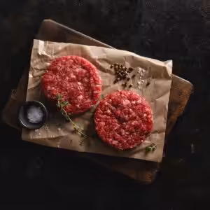 Hamburguesas de vaca artesana Discarlux, 2 x 180 g, sobre papel y tabla de madera